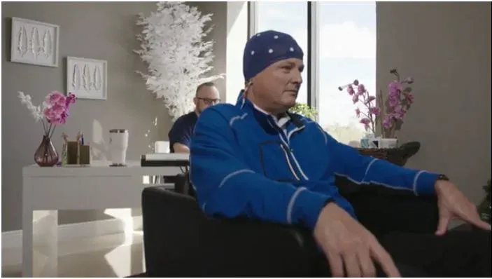 Golf Channel’s Charlie Rymer wears a qEEG sensor cap during a brain-map session with Adrian Quevedo
